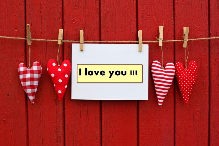 I love you message with hearts on wood planks