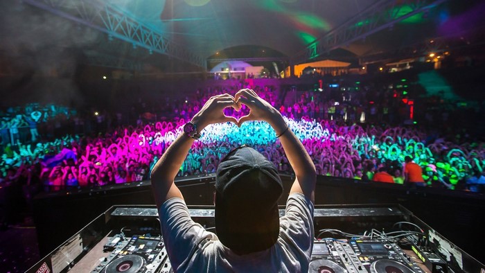 DJ with hands in heart shape at concert