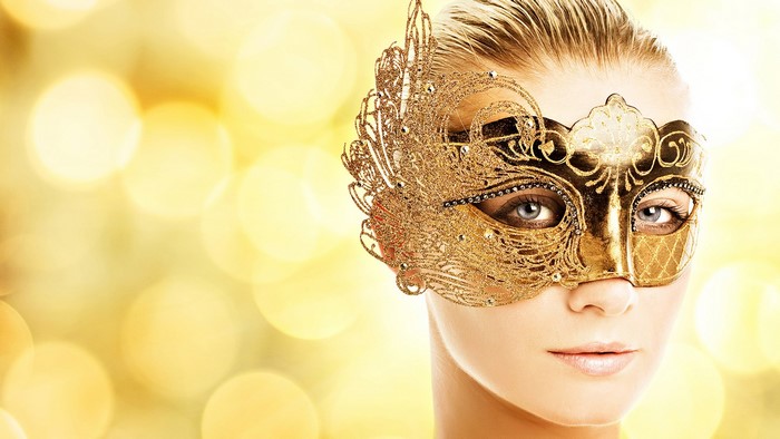 Woman wearing a golden masquerade mask
