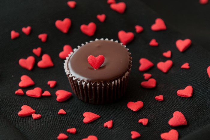 Chocolate cupcake with red heart sprinkles
