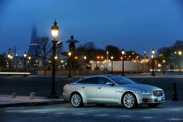 Silver Jaguar XJ parked in Paris at dusk