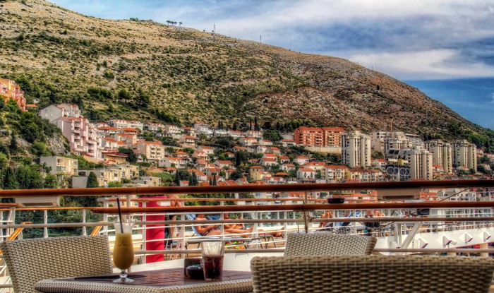 View of Dubrovnik from a cruise ship deck with drinks