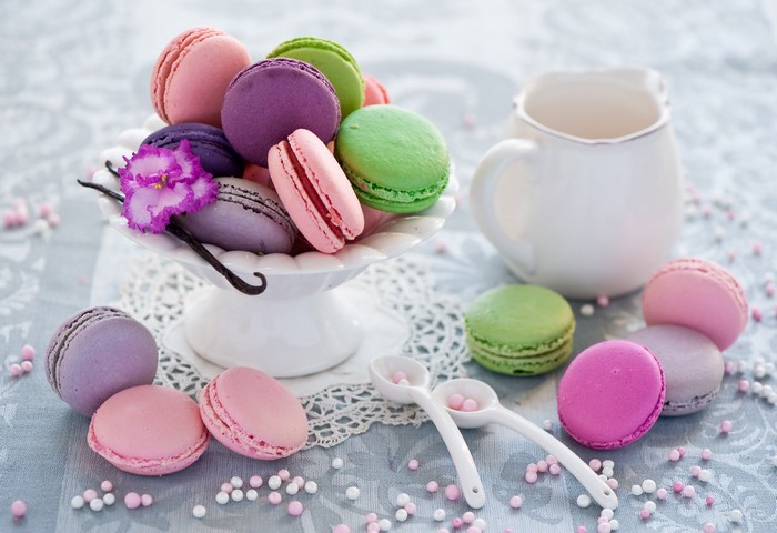 Macarons in a bowl with a pitcher