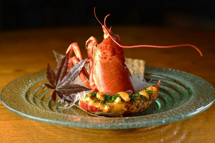 Cooked Lobster Tail with Cashews and Herbs on Plate