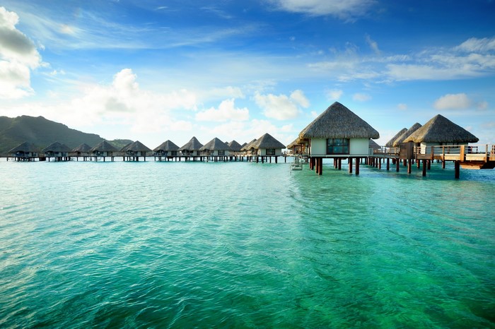 Overwater bungalows in French Polynesia on a sunny day