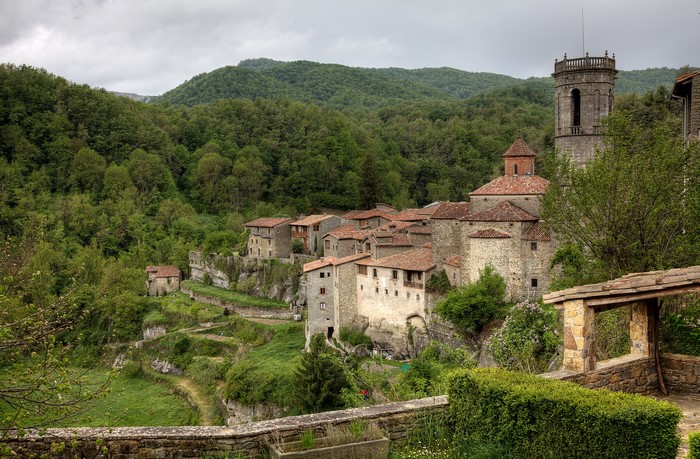 Stone village with a tower in a green forest