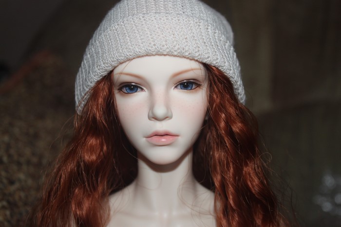 Doll with red hair wearing a winter hat