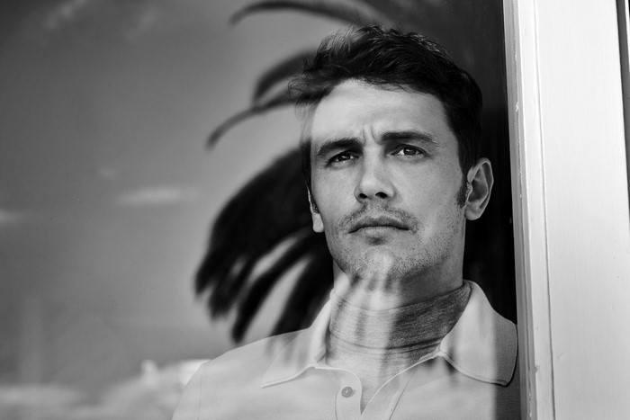James Franco looking through a window