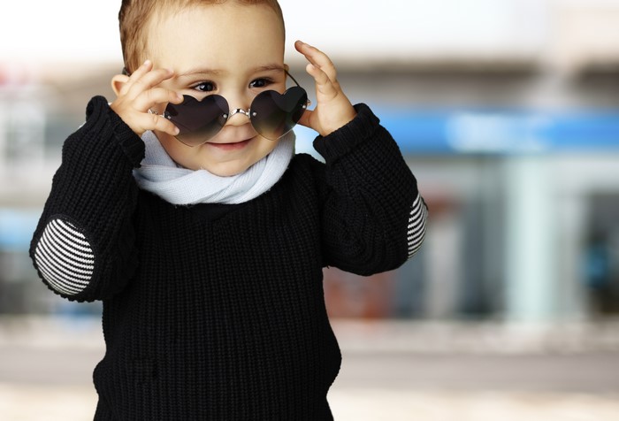 Baby boy wearing heart sunglasses and black sweater
