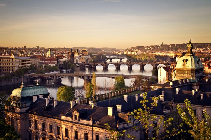 Prague cityscape with bridges over Vltava River at sunset