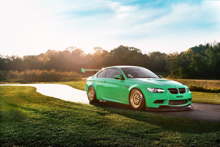 Green BMW M3 with a large rear spoiler