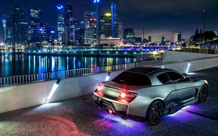 Mazda RX-8 modified with underglow lights at night