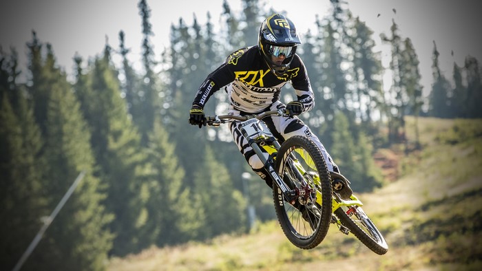 Downhill mountain biker in mid-air jump