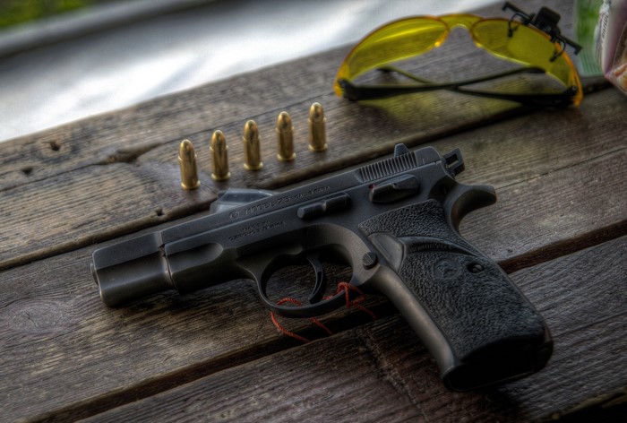 CZ Model 75 pistol with cartridges and sunglasses