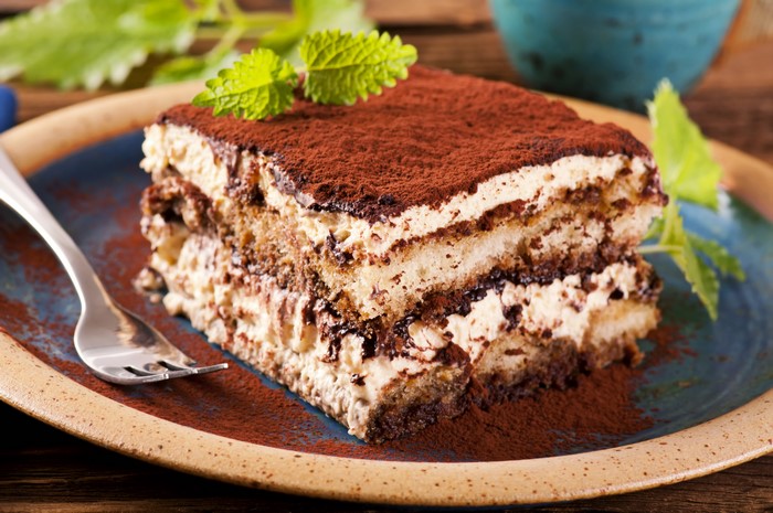 Tiramisu dessert with cocoa powder and mint