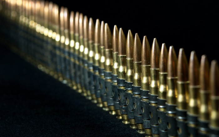 A belt of bullets on a black background