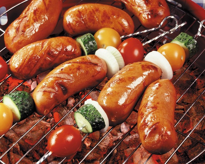 Sausages and vegetables on a grill