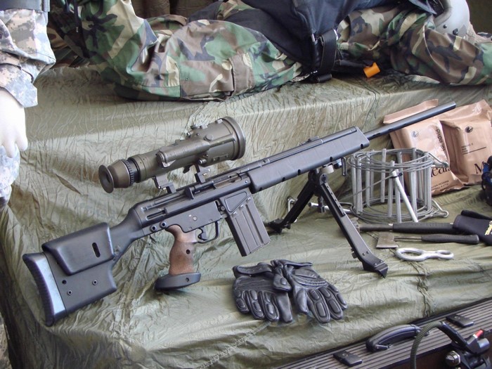 Sniper rifle with telescopic sight and military gear