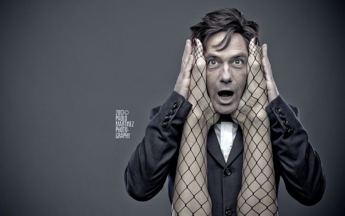 Man with fishnet-clad legs over his face