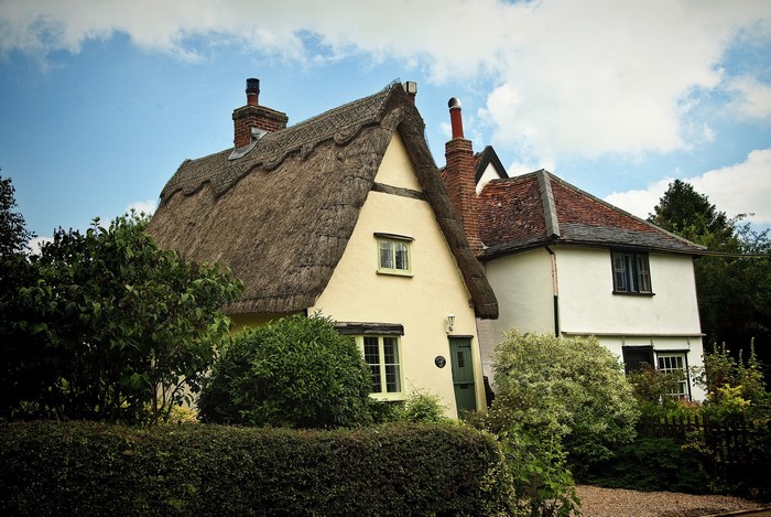 Thatched roof cottage and white house in Suffolk, UK