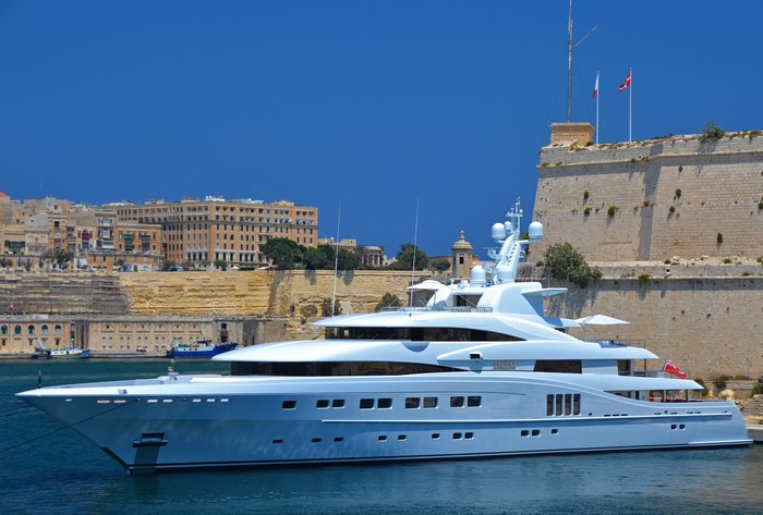 Luxury Yacht docked near historic fortifications