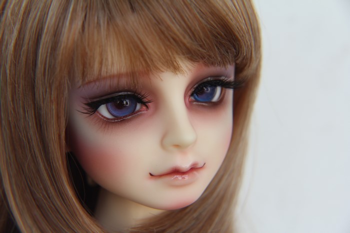 Doll with dark blonde hair and blue eyes