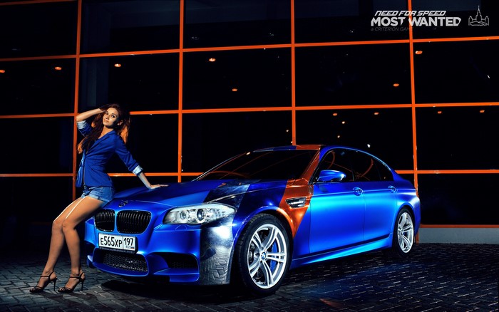Woman posing with a blue BMW M5