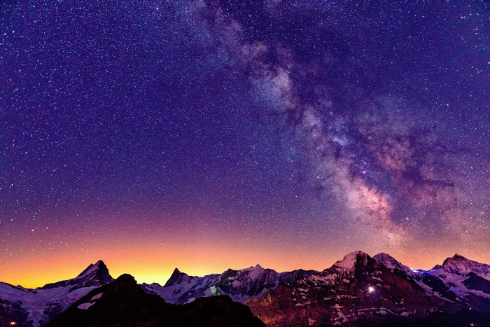Milky Way over snow-capped mountains in Switzerland