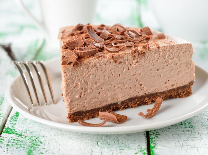 Chocolate mousse cake slice with chocolate shavings and fork