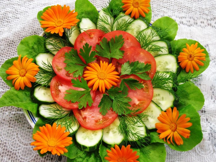 Salad with tomatoes, cucumbers, lettuce, and flowers