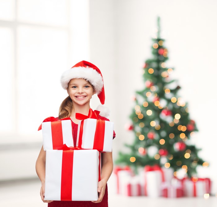 Smiling Girl with Christmas Gifts and Tree 4K