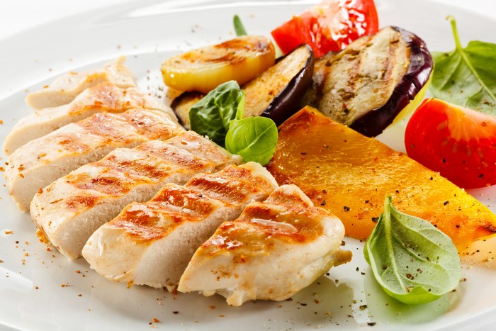 Sliced grilled chicken breast with roasted vegetables