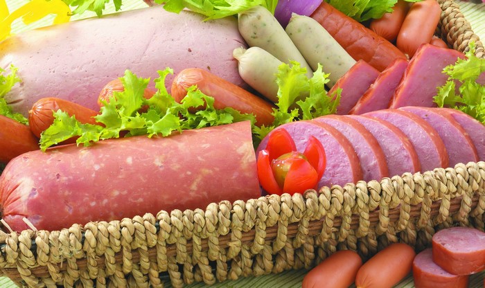 Assortment of meat products and sausages in a basket