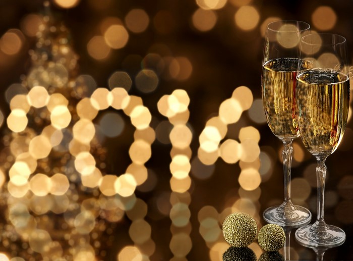 Champagne glasses and 2014 text with bokeh lights