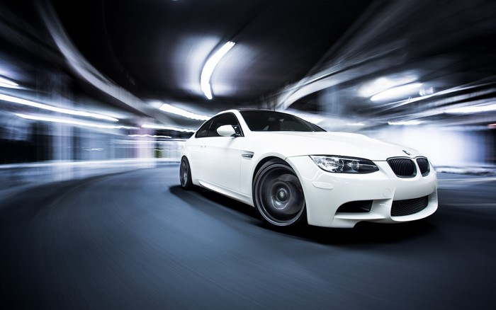 White BMW M3 driving through a tunnel
