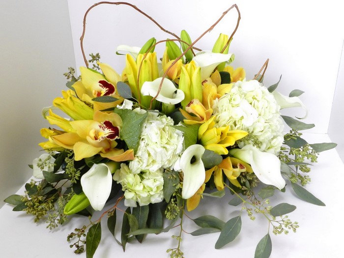 Yellow orchids and white calla lilies floral arrangement
