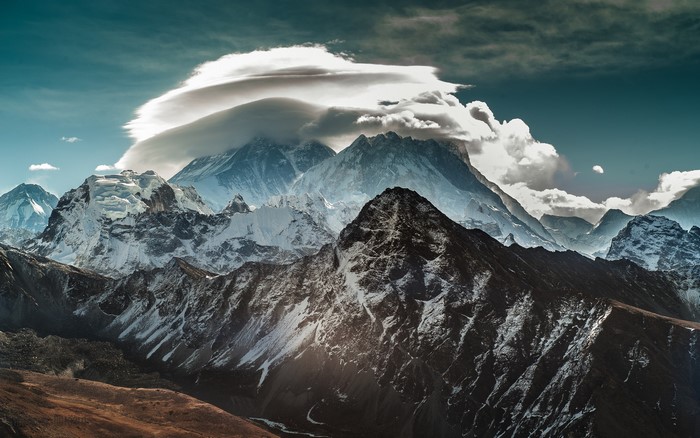 Majestic mountain range with lenticular clouds