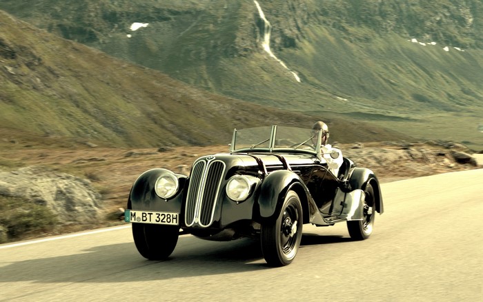 Black BMW Retro Cabriolet driving on a mountain road