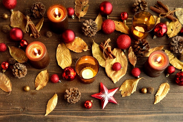 Christmas candles with ornaments and pine cones