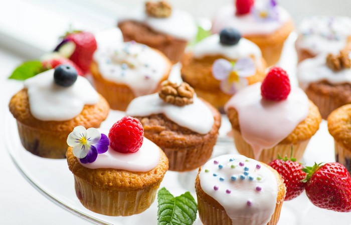 Assortment of decorated cupcakes on a glass stand