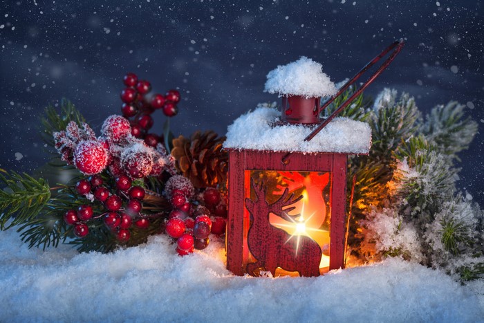 Christmas lantern with deer, berries, and snow