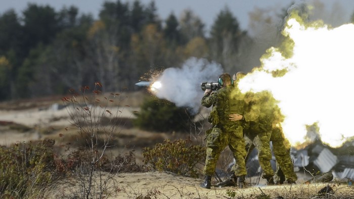 Soldiers firing a grenade launcher with explosion
