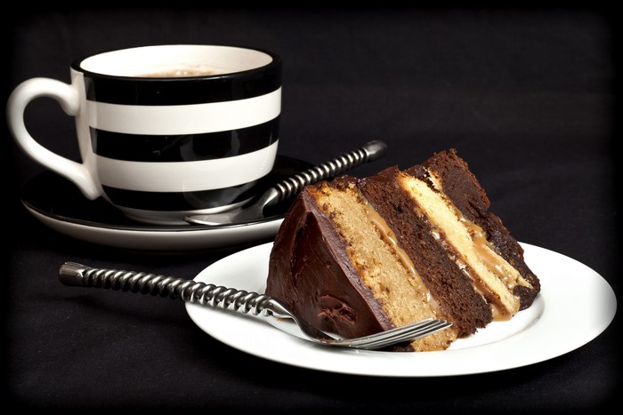 Chocolate cake slice with coffee and fork