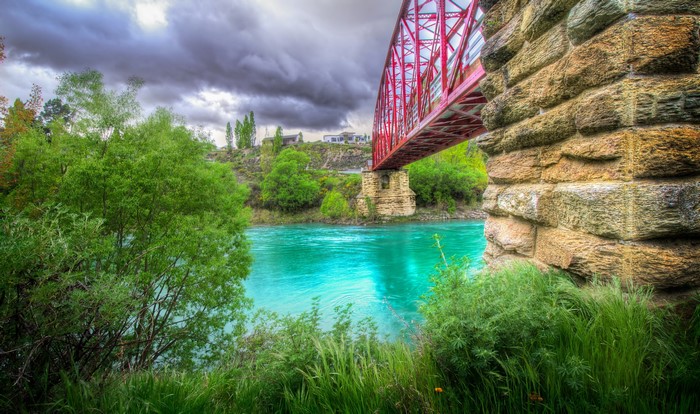 Red Bridge Over Turquoise River in New Zealand