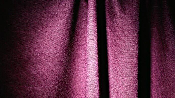 Violet textured curtains with dramatic lighting
