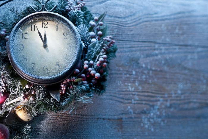 Christmas clock on a wooden background