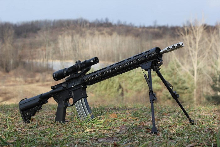 AR-15 rifle with scope and bipod on grass