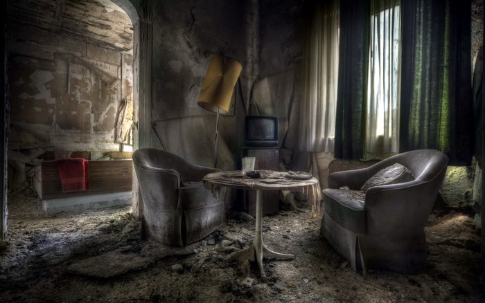 Abandoned room with armchair and television