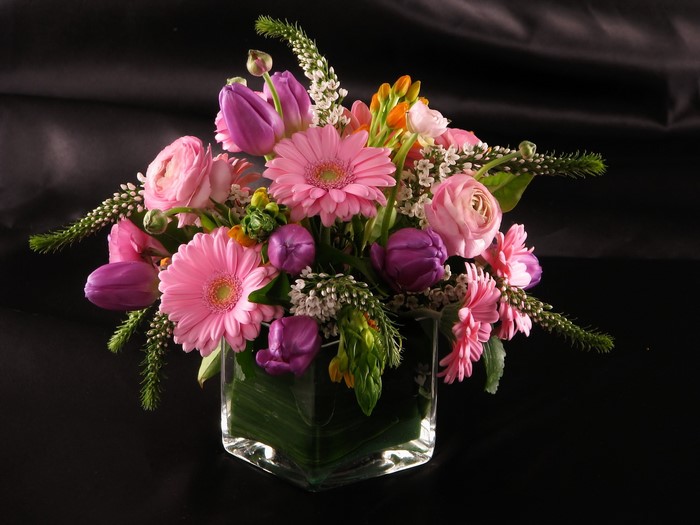 Pink and purple flower arrangement in a glass vase