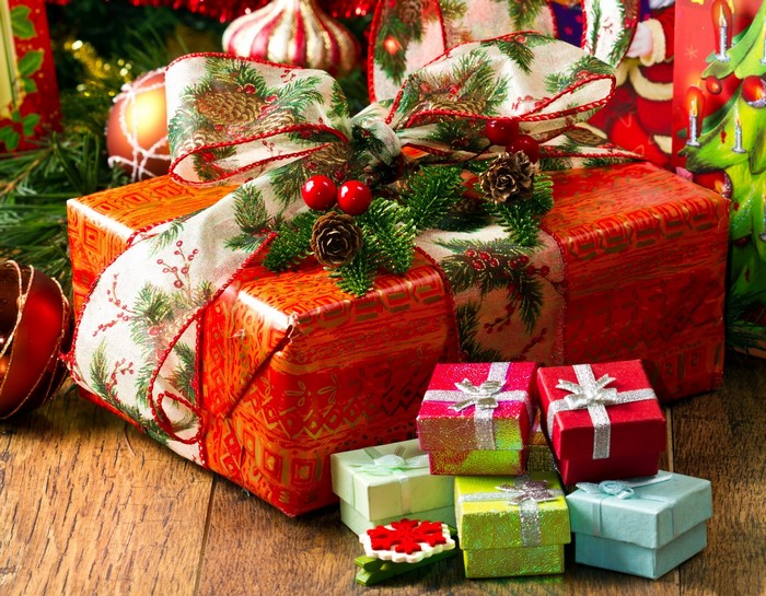 Christmas gifts wrapped in red and gold paper with festive ribbon